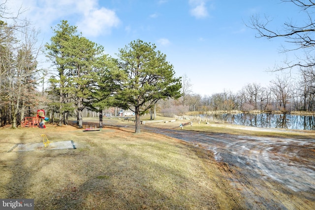 view of yard featuring a playground and a water view