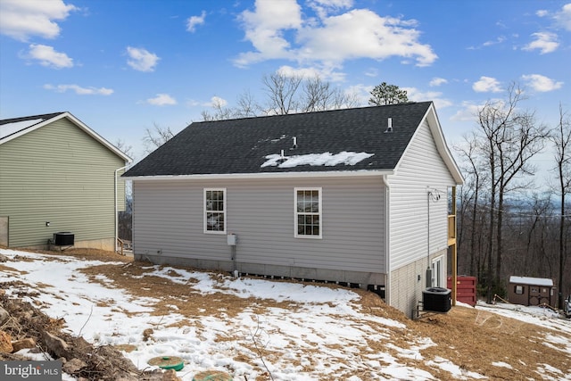 snow covered house with cooling unit