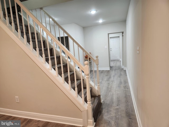 staircase with wood-type flooring