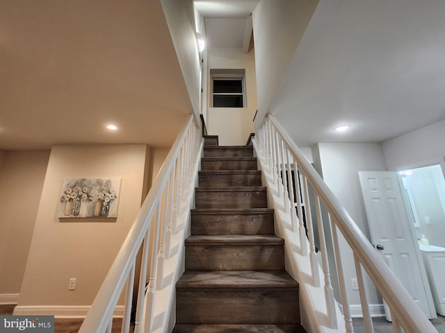 staircase with hardwood / wood-style flooring