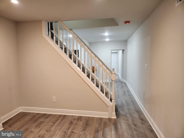 stairway with hardwood / wood-style floors