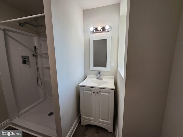 bathroom featuring vanity, a shower, and wood-type flooring