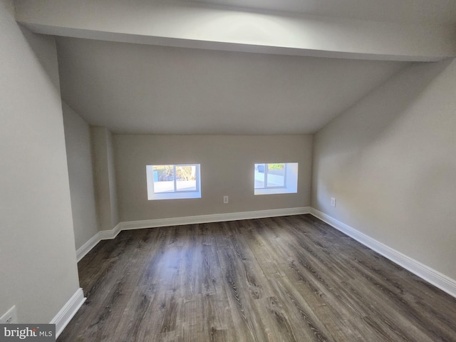 empty room featuring dark hardwood / wood-style floors and vaulted ceiling