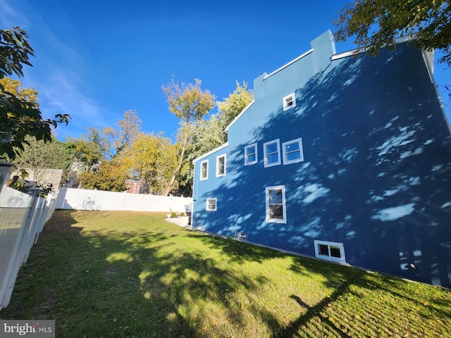 view of home's exterior with a yard