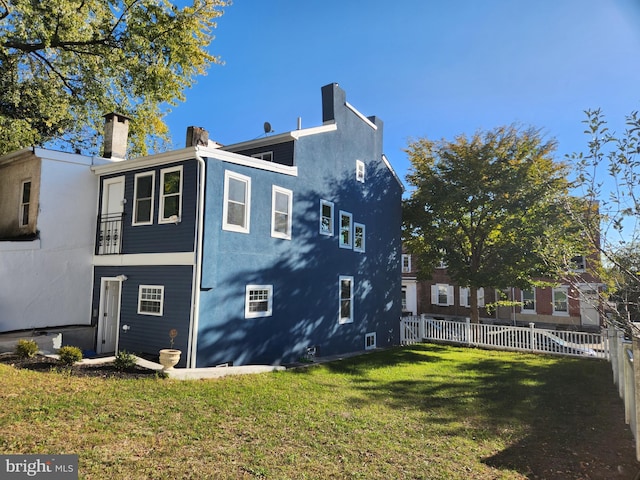 view of side of home with a yard