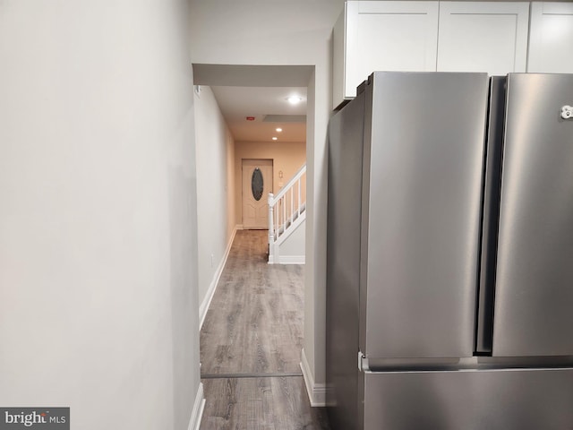 corridor with hardwood / wood-style flooring