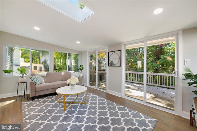 sunroom / solarium featuring a healthy amount of sunlight and vaulted ceiling with skylight