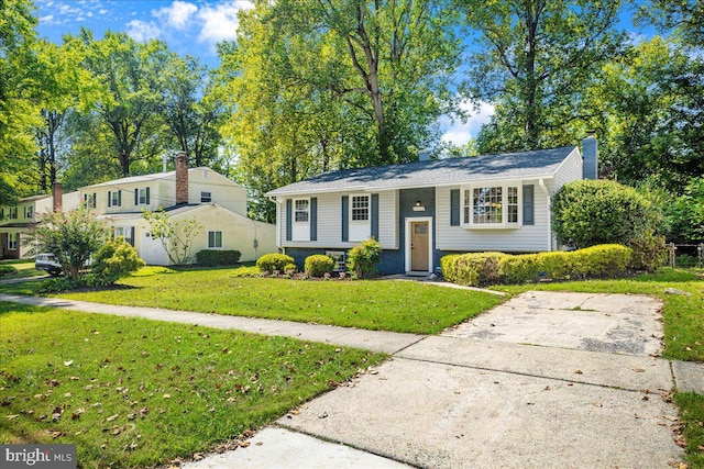 split foyer home with a front lawn