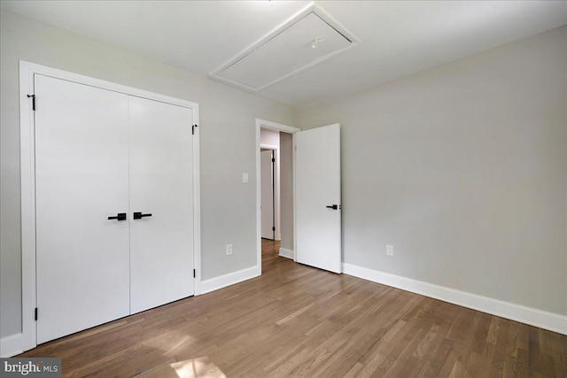 unfurnished bedroom featuring light hardwood / wood-style flooring and a closet