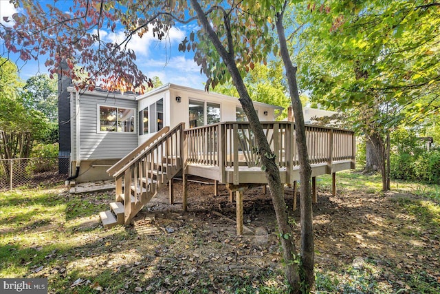 rear view of house with a wooden deck