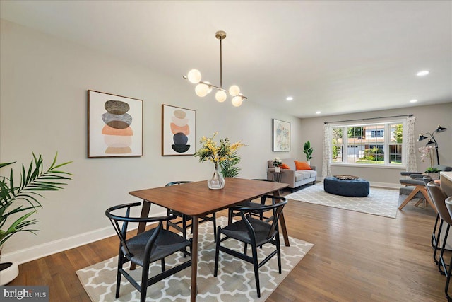 dining area featuring an inviting chandelier and dark hardwood / wood-style flooring