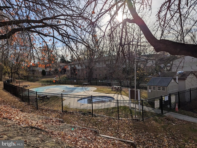 view of pool with a patio and an outdoor structure