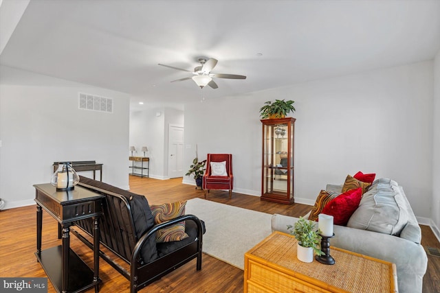 living room featuring hardwood / wood-style flooring and ceiling fan