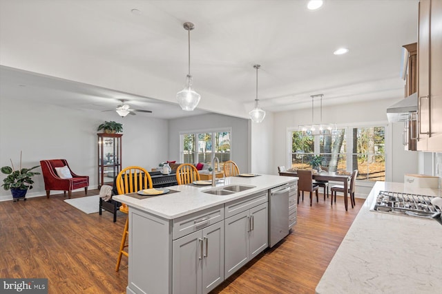 kitchen with a center island with sink, dark wood-type flooring, sink, and stainless steel appliances