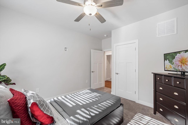 bedroom featuring ceiling fan and light carpet