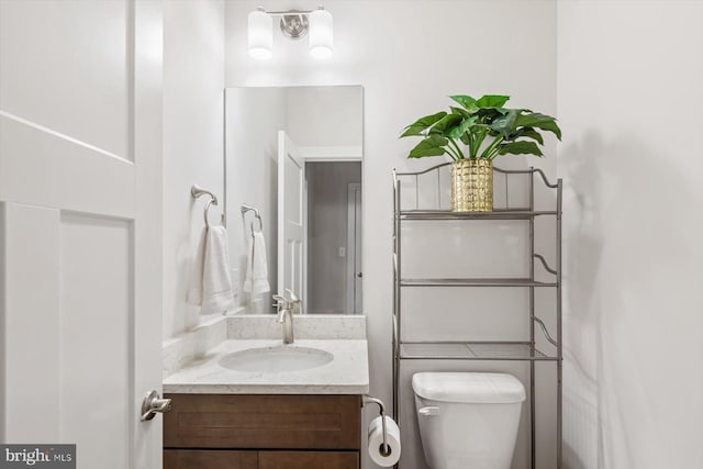 bathroom featuring vanity and toilet