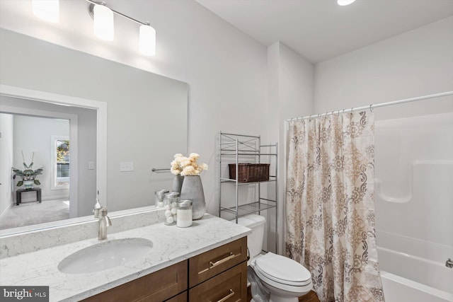 full bathroom featuring vanity, shower / tub combo, and toilet