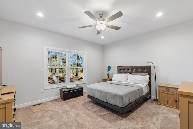 bedroom with ceiling fan and light carpet