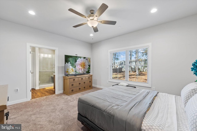 carpeted bedroom with connected bathroom and ceiling fan