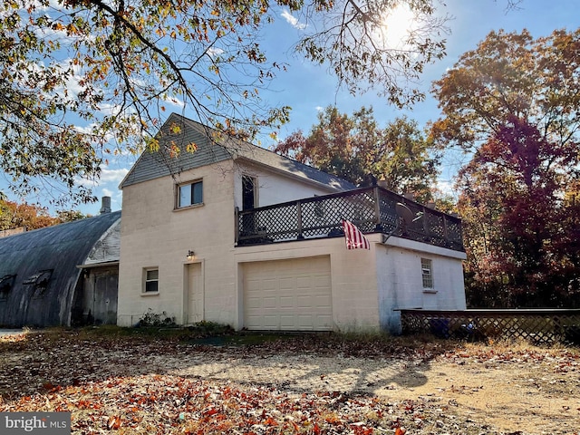 back of property with a garage