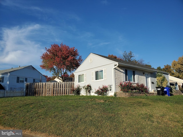 view of side of home with a yard