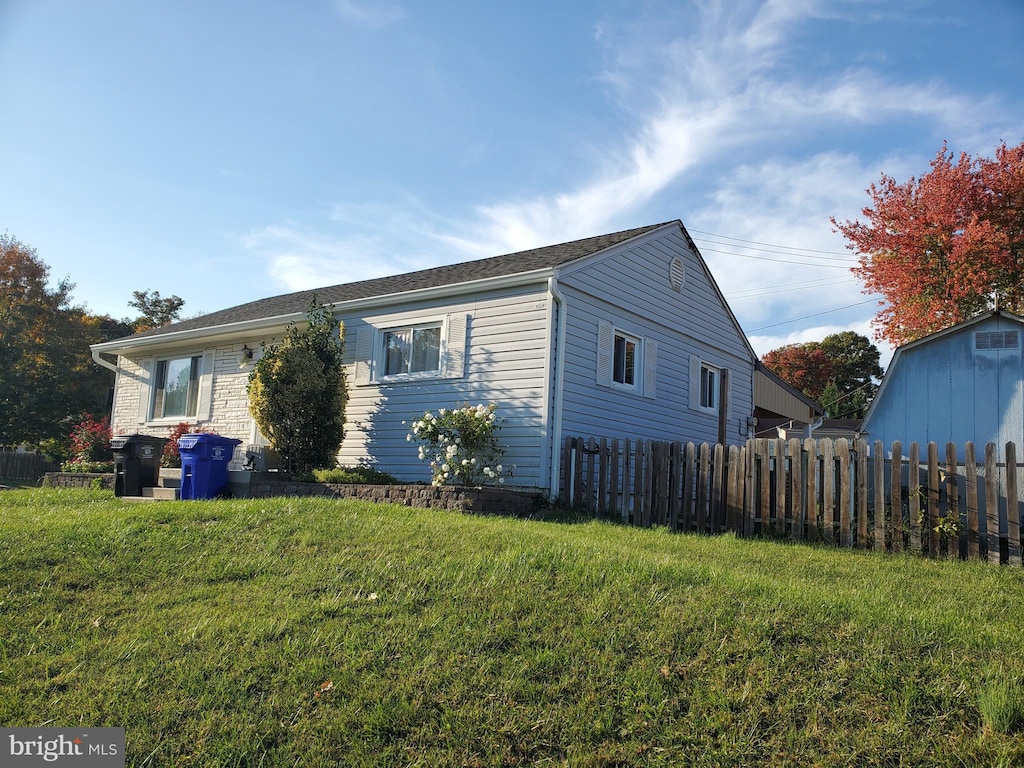 view of property exterior featuring a lawn