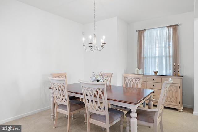 carpeted dining space featuring a chandelier