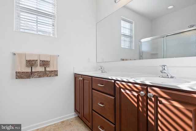 bathroom featuring vanity and an enclosed shower