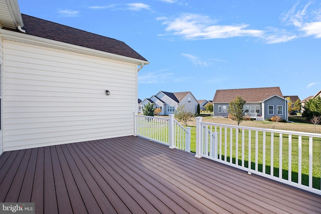 wooden terrace featuring a yard