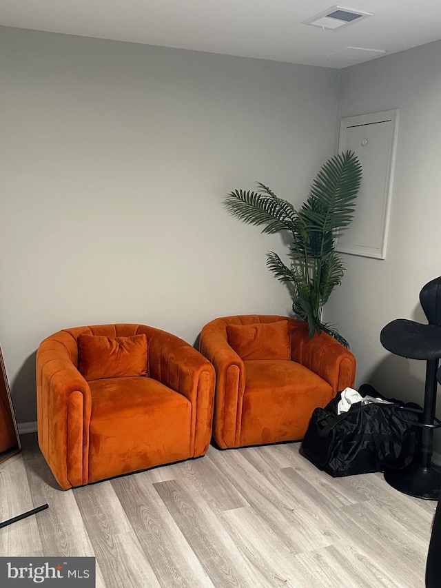 sitting room featuring light hardwood / wood-style flooring