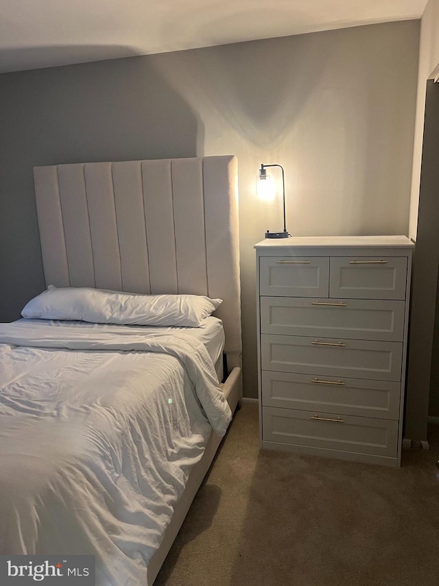 bedroom with dark colored carpet