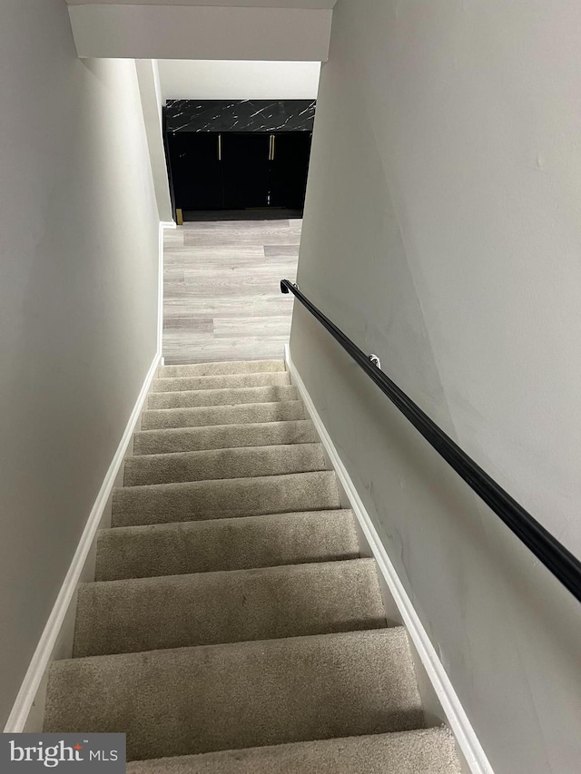 stairs featuring wood-type flooring