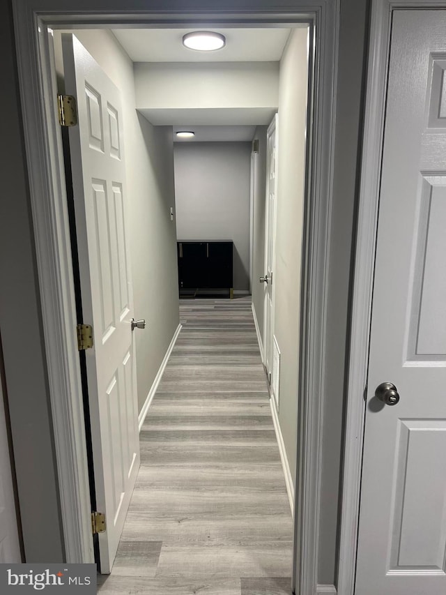 corridor with light hardwood / wood-style flooring