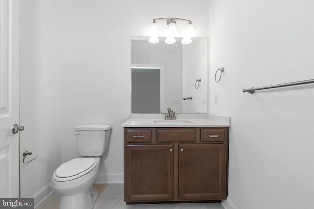 bathroom with vanity, toilet, and tile patterned flooring