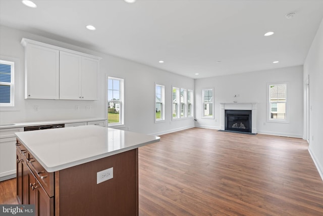 kitchen with a healthy amount of sunlight, light hardwood / wood-style flooring, and white cabinets