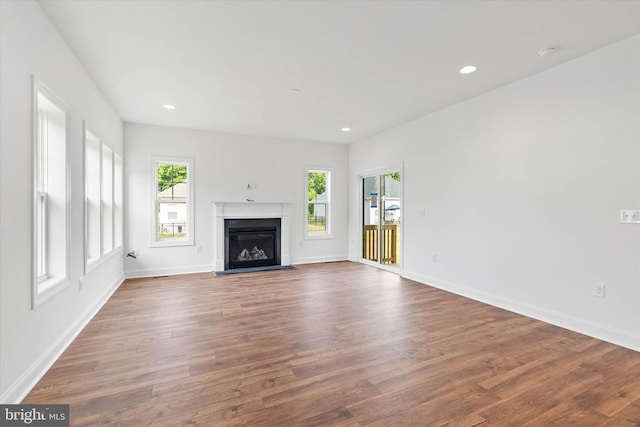 unfurnished living room with dark hardwood / wood-style floors