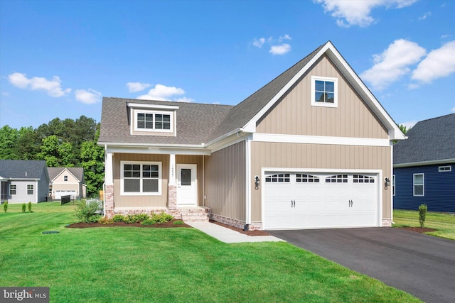 craftsman house with a front yard and a garage