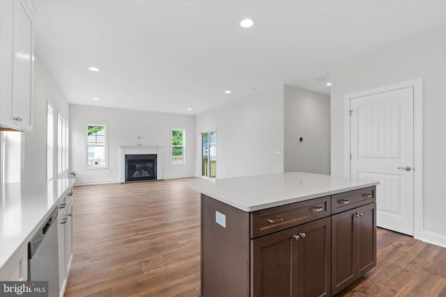 kitchen featuring dishwasher, dark hardwood / wood-style floors, dark brown cabinets, a center island, and white cabinets