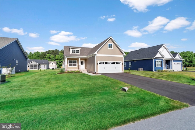 craftsman house with a front lawn, central AC unit, and a garage