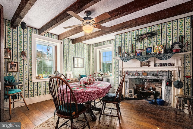 dining area featuring beamed ceiling, hardwood / wood-style floors, plenty of natural light, and ceiling fan