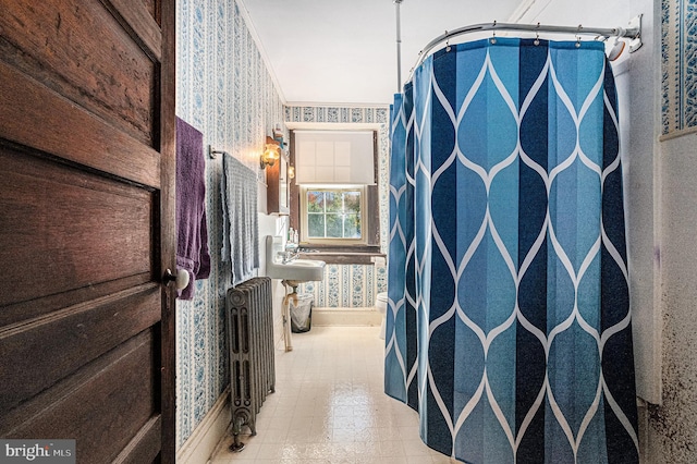 corridor featuring ornamental molding and radiator