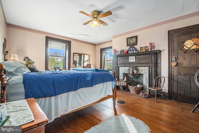 bedroom featuring ornamental molding, hardwood / wood-style flooring, and ceiling fan