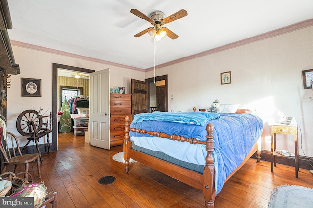 bedroom featuring crown molding, wood-type flooring, and ceiling fan