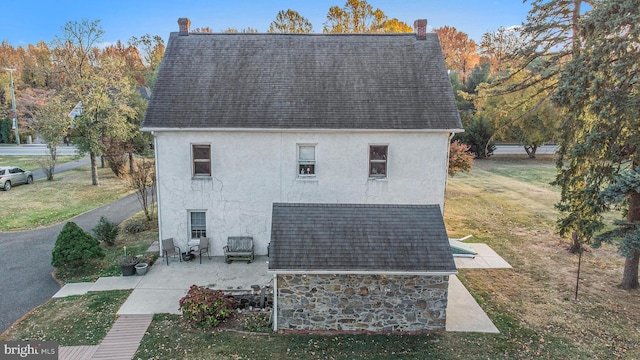 view of property exterior featuring a yard and a patio area