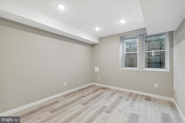 unfurnished room with light wood-type flooring