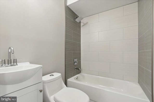 full bathroom with vanity, tiled shower / bath, and toilet