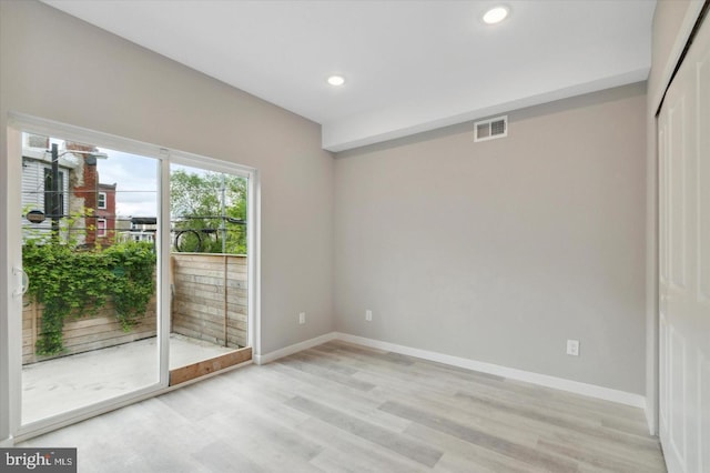 unfurnished room with light hardwood / wood-style flooring