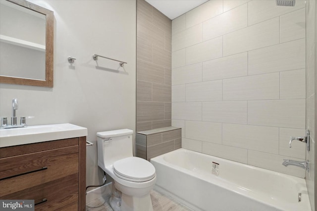 full bathroom featuring vanity, tiled shower / bath combo, wood-type flooring, and toilet