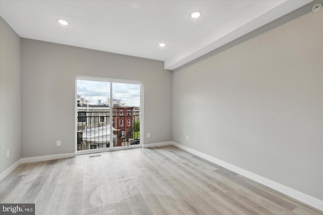 spare room featuring light hardwood / wood-style floors