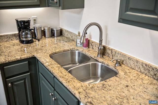 kitchen with light stone counters and sink